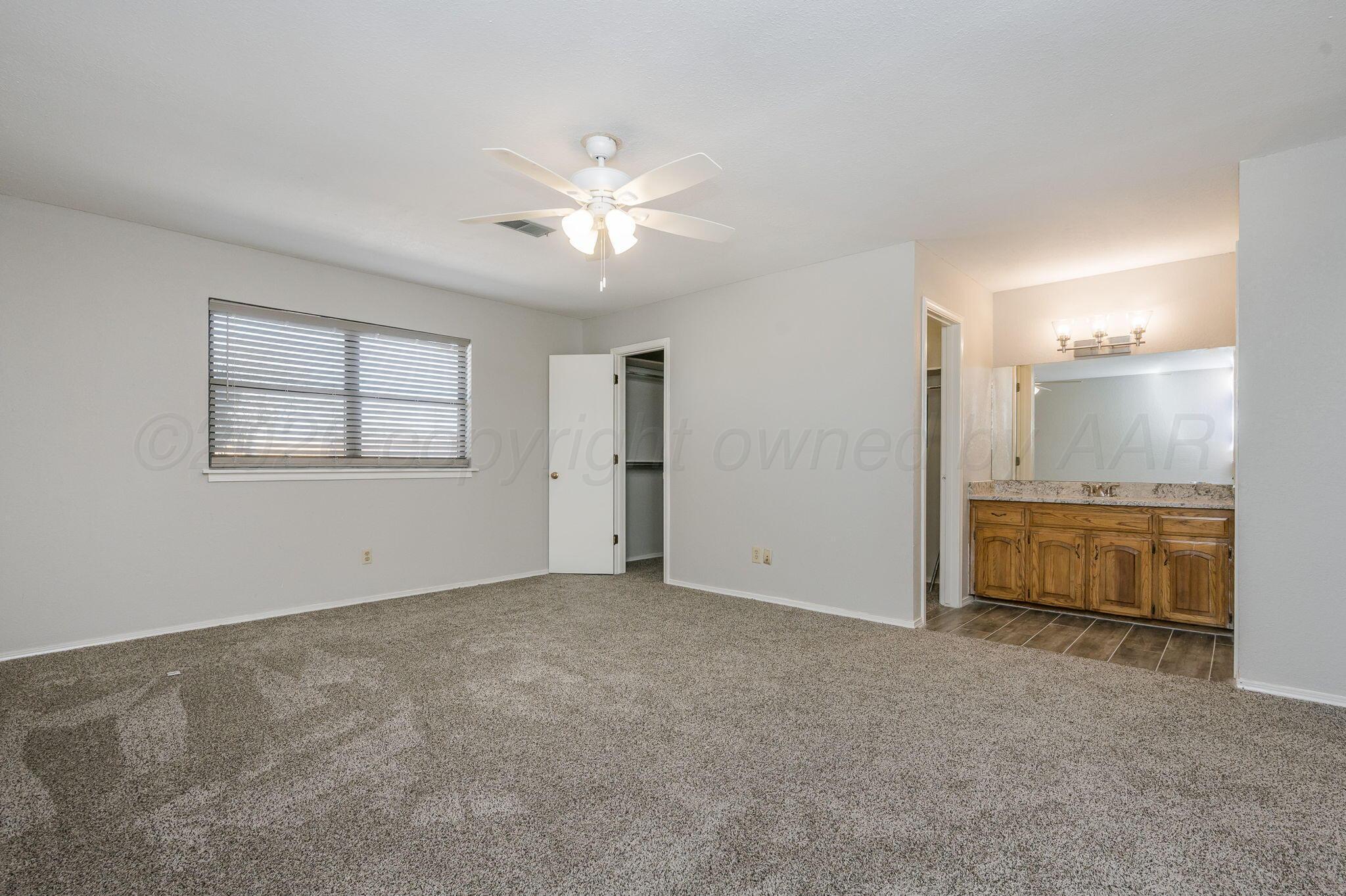 6000 Hampton Drive Amarillo, TX 79109 - Photo 10 of 19 an empty room with windows and cabinet