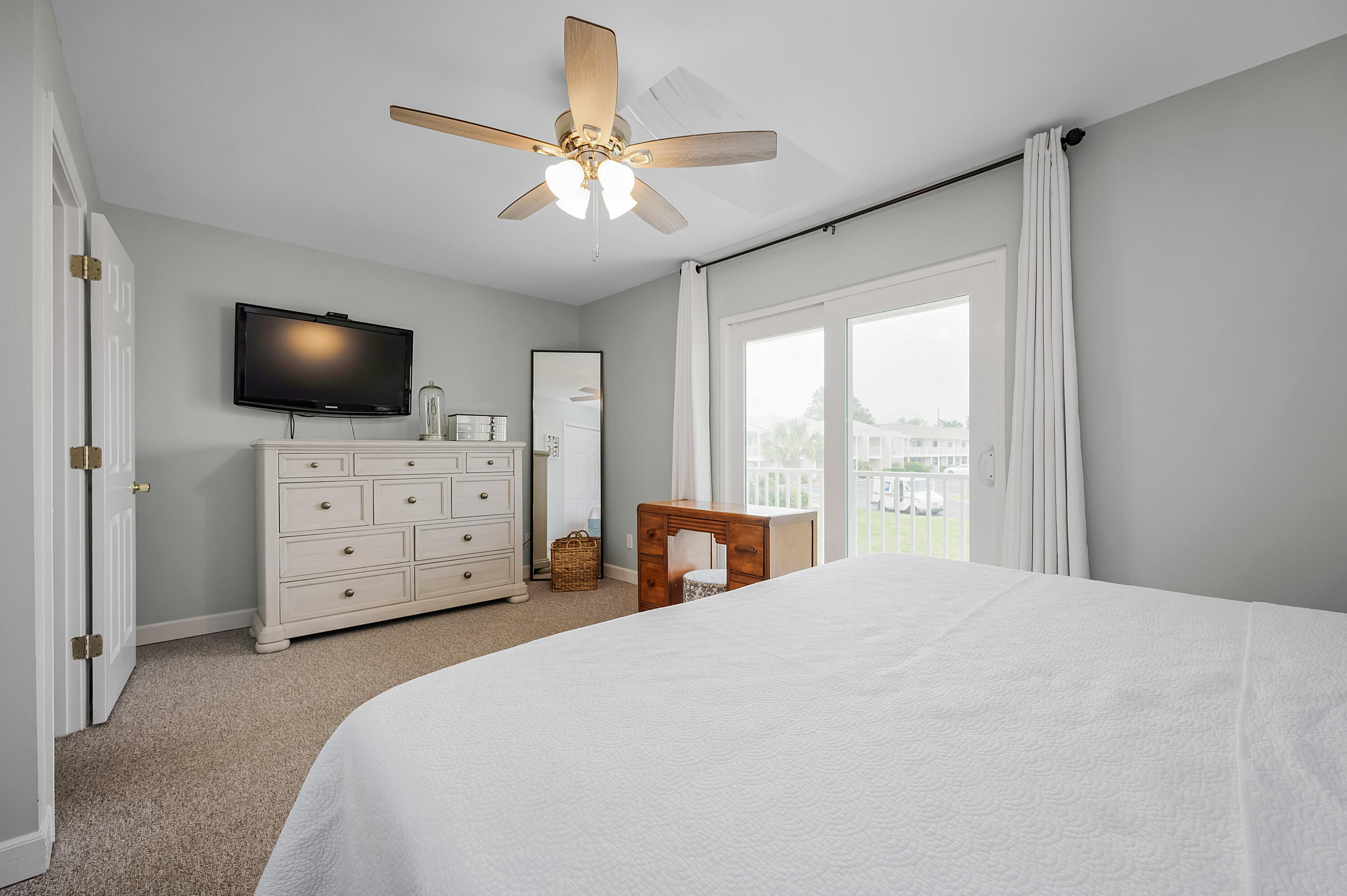 241 Ellis Road, Unit 43 Miramar Beach, FL 32550 - Photo 5 of 43 a spacious bedroom with a bed and a flat screen tv