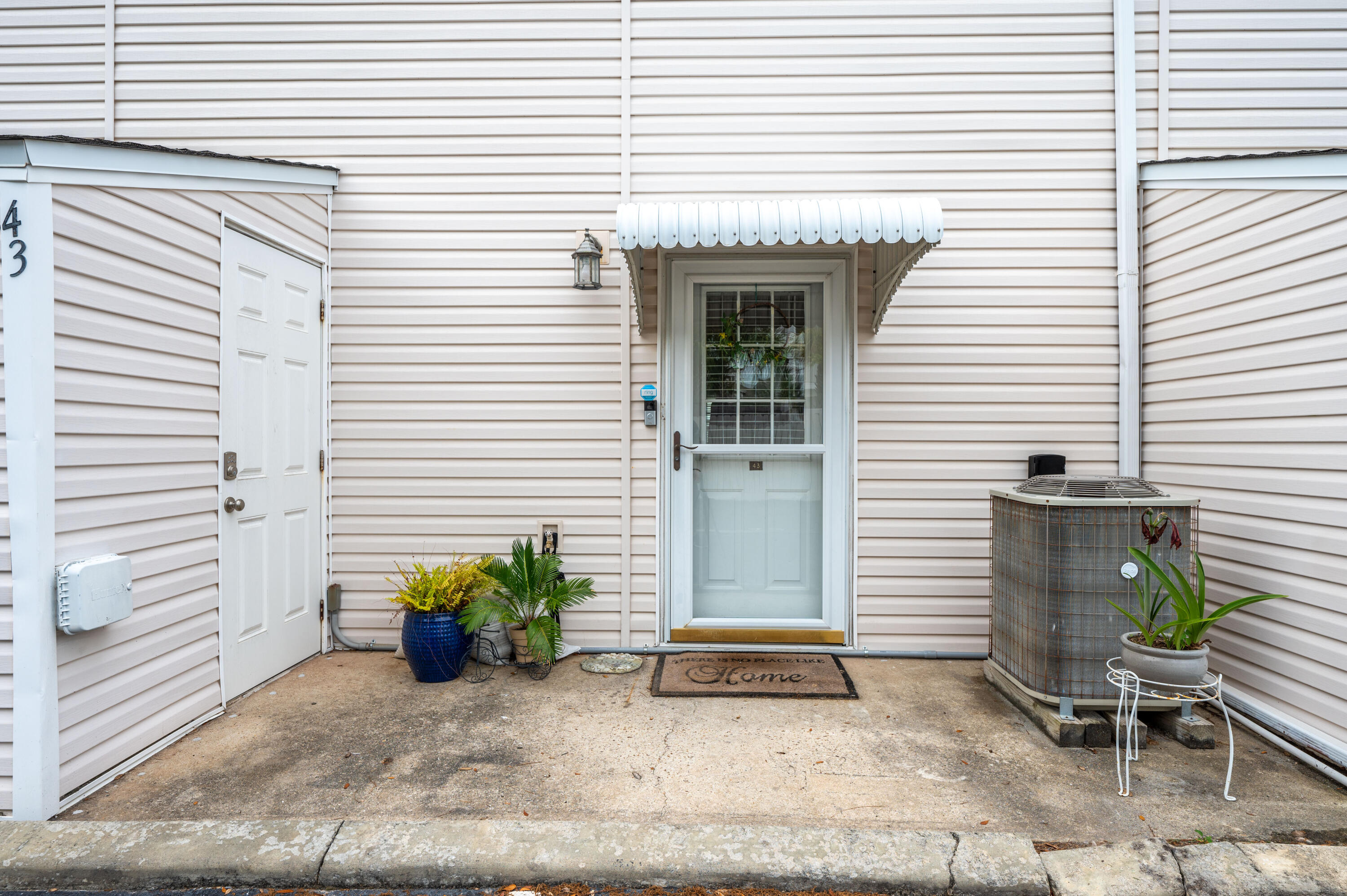 241 Ellis Road, Unit 43 Miramar Beach, FL 32550 - Photo 8 of 43 a view of a house with chairs and potted plants