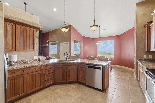 2567 West Rim Rock Drive Stockton, UT 84071 - Photo 8 of 64 Kitchen featuring wood cabinetry, light-toned countertops, and tile flooring