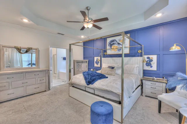 a living room with furniture and a ceiling fan