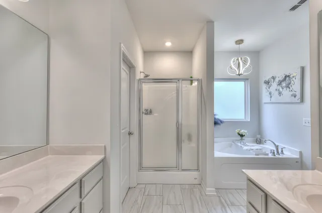 a bathroom with a granite countertop sink a mirror and a shower