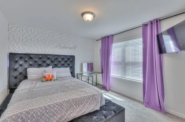 a bedroom with a bed and a window