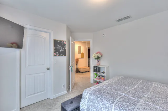 a bedroom with a bed and a cabinets