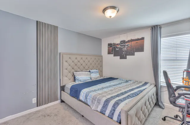 a bedroom with a bed and chair