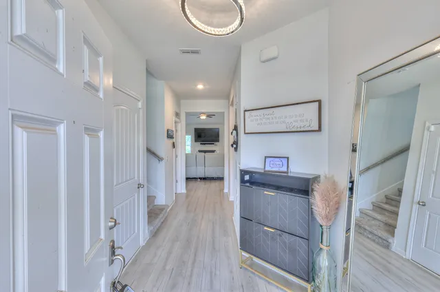 a view of a kitchen with a refrigerator and a stove top oven