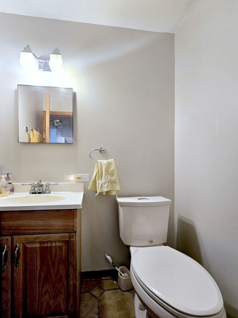 357 North Pioneer Drive Addison, IL 60101 - Photo 14 of 26 a white toilet sitting next to a bathroom sink