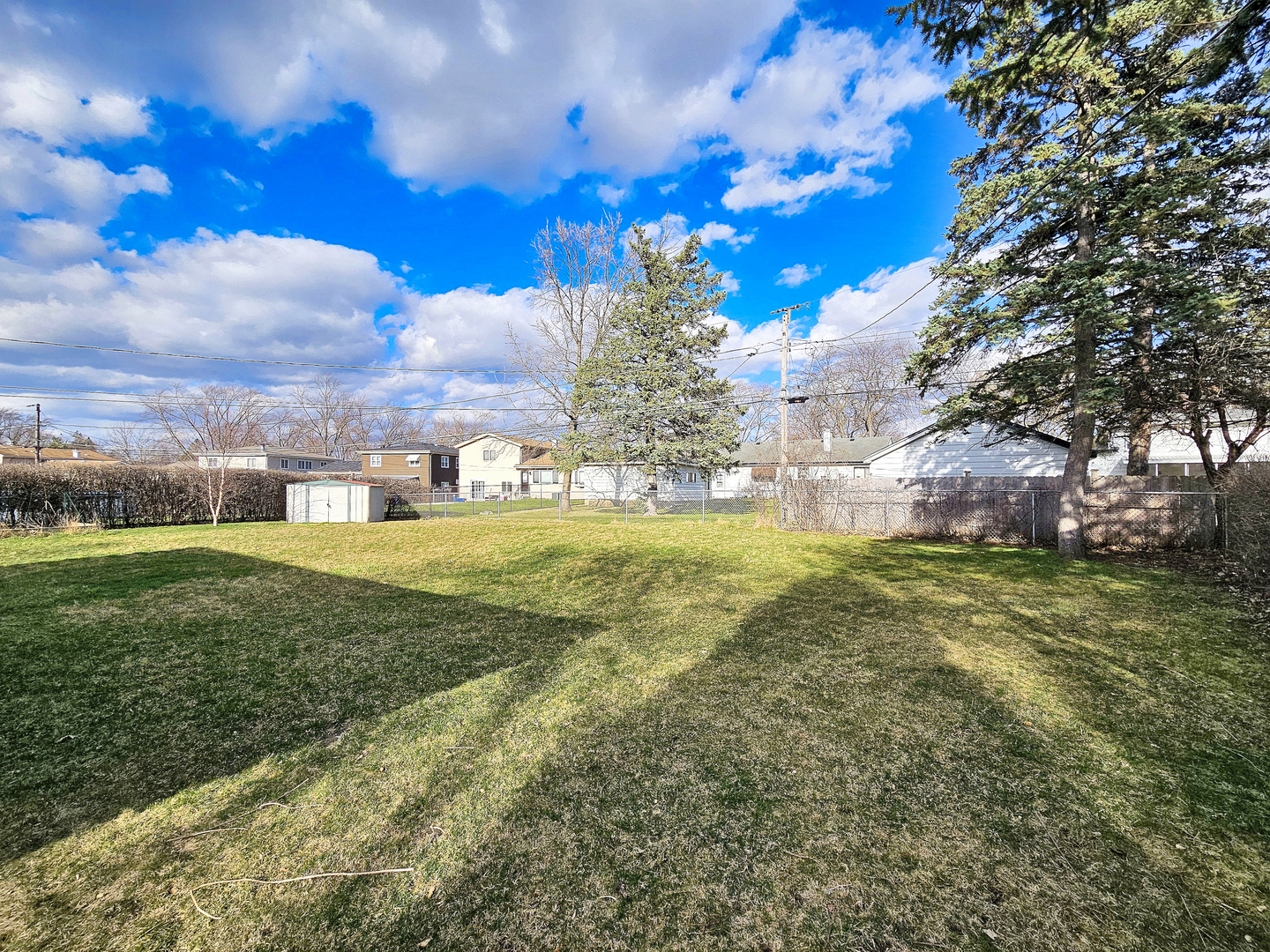 357 North Pioneer Drive Addison, IL 60101 - Photo 24 of 26 a view of a big yard with a large tree