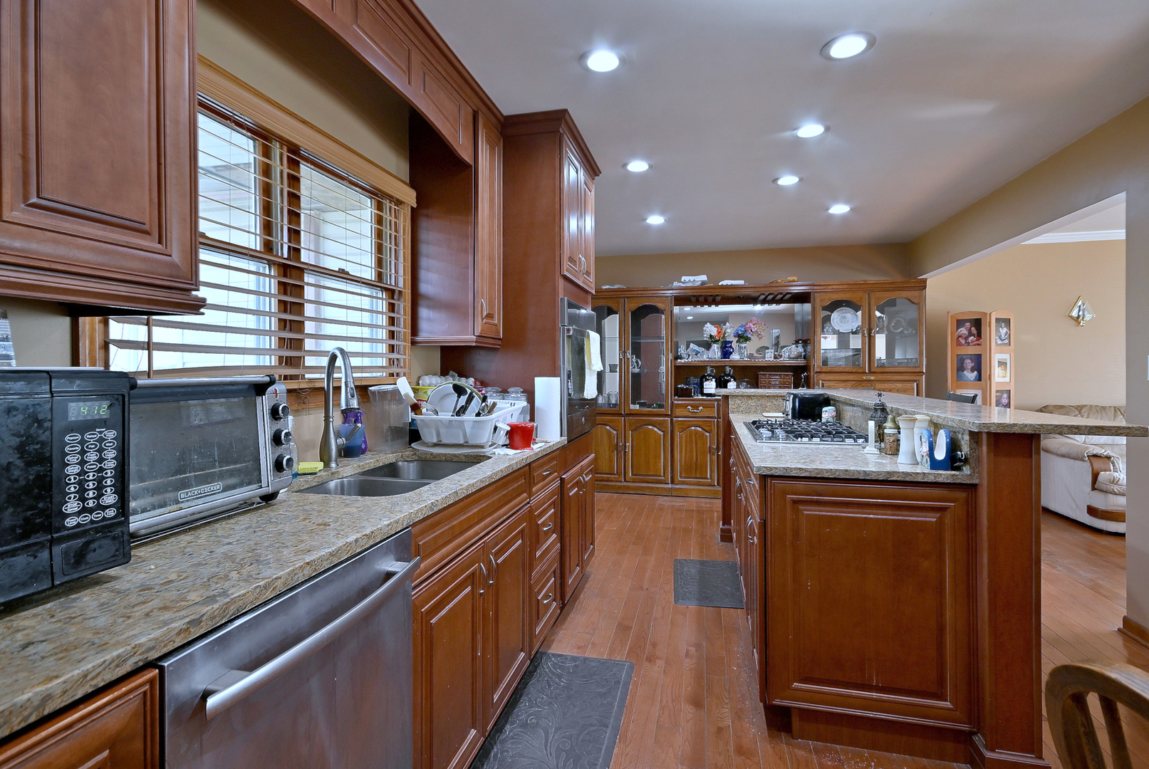 357 North Pioneer Drive Addison, IL 60101 - Photo 6 of 26 a kitchen with stainless steel appliances granite countertop sink stove top oven and cabinets