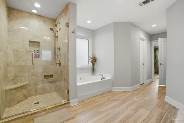 a bathroom with a bathtub and a shower