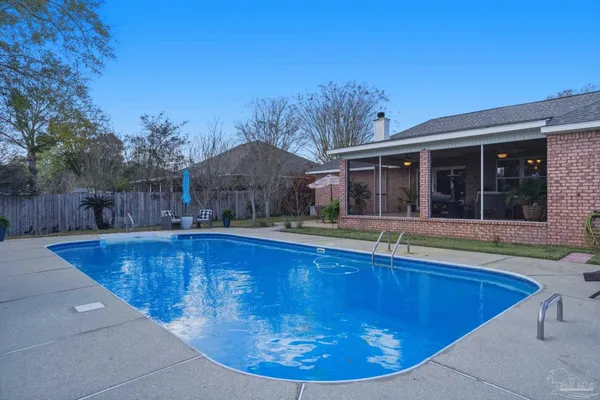 a view of a house with swimming pool in front of it
