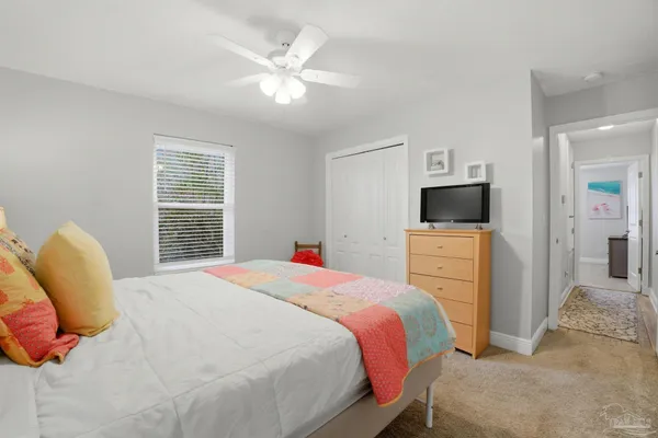 a bedroom with a bed and a television