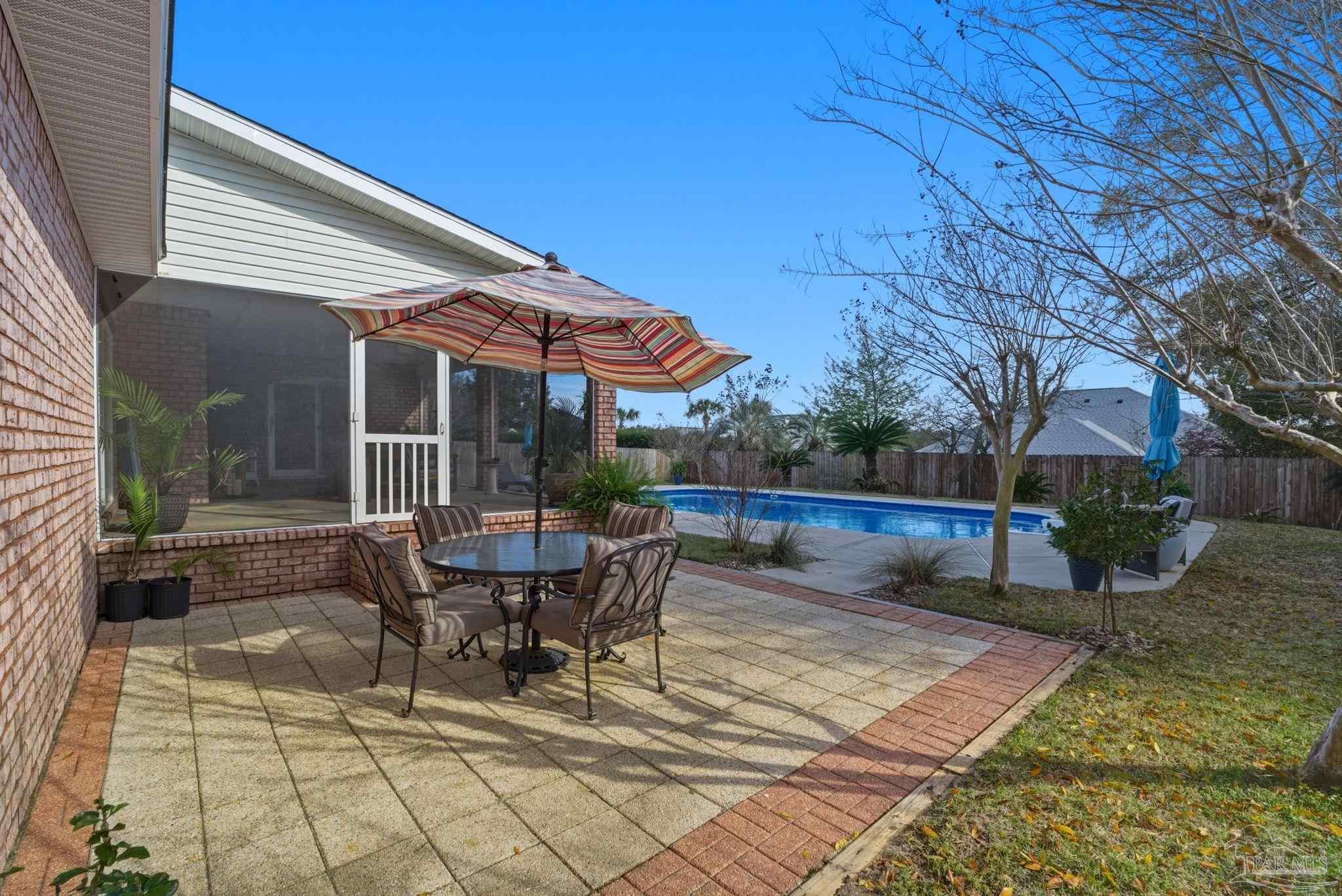 4249 Spindlewick Drive Pace, FL 32571 - Photo 25 of 26 a view of a patio with table and chairs and potted plants