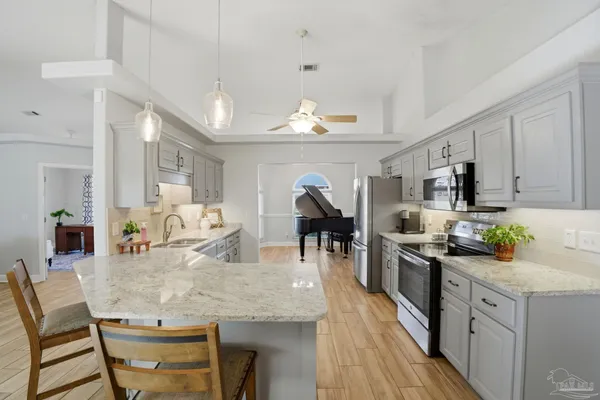 a kitchen with sink cabinets and dining table