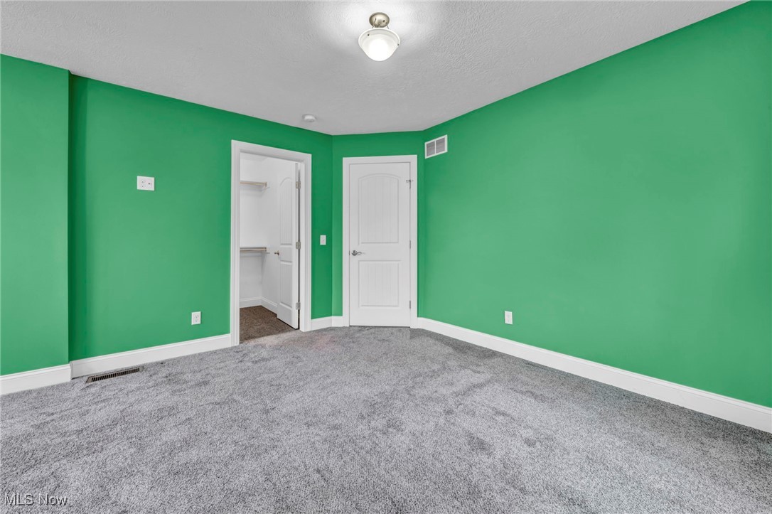 10020 Fair Road Strongsville, OH 44149 - Photo 24 of 47 Unfurnished bedroom featuring carpet and a spacious closet