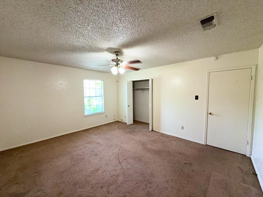 1613 Edgehill Road Benbrook, TX 76126 - Photo 9 of 22 an empty room with windows and chandelier fan