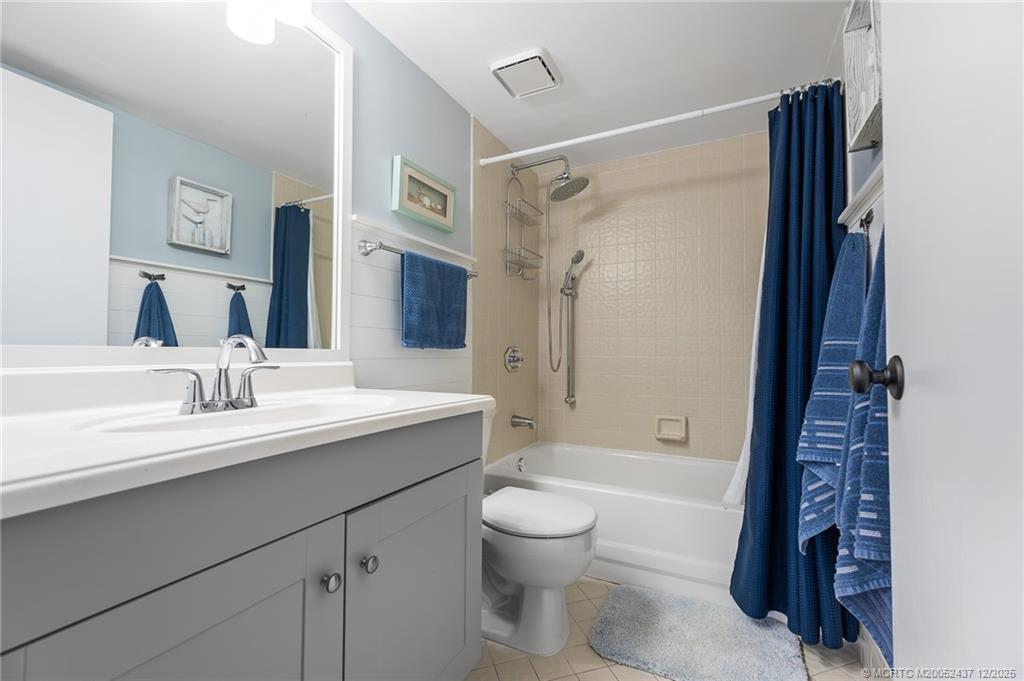 3171 Southeast Aster Lane, Unit 1103 Stuart, FL 34994 - Photo 12 of 26 a bathroom with a sink a toilet and shower