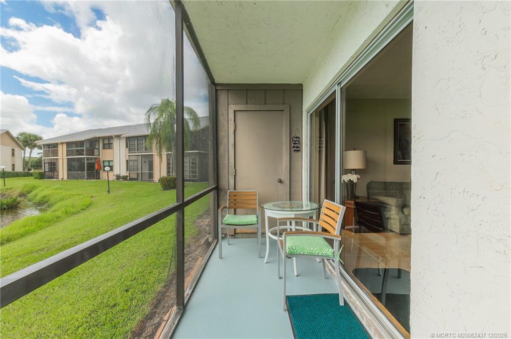 3171 Southeast Aster Lane, Unit 1103 Stuart, FL 34994 - Photo 18 of 26 a balcony with view of swimming pool