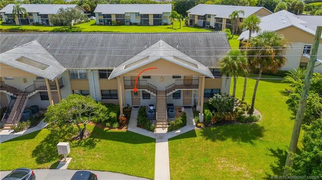 a aerial view of a house with a yard table and chairs