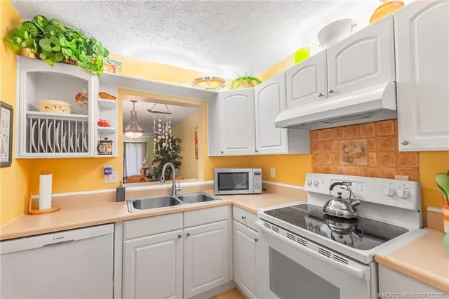 a kitchen with stainless steel appliances granite countertop a sink and cabinets