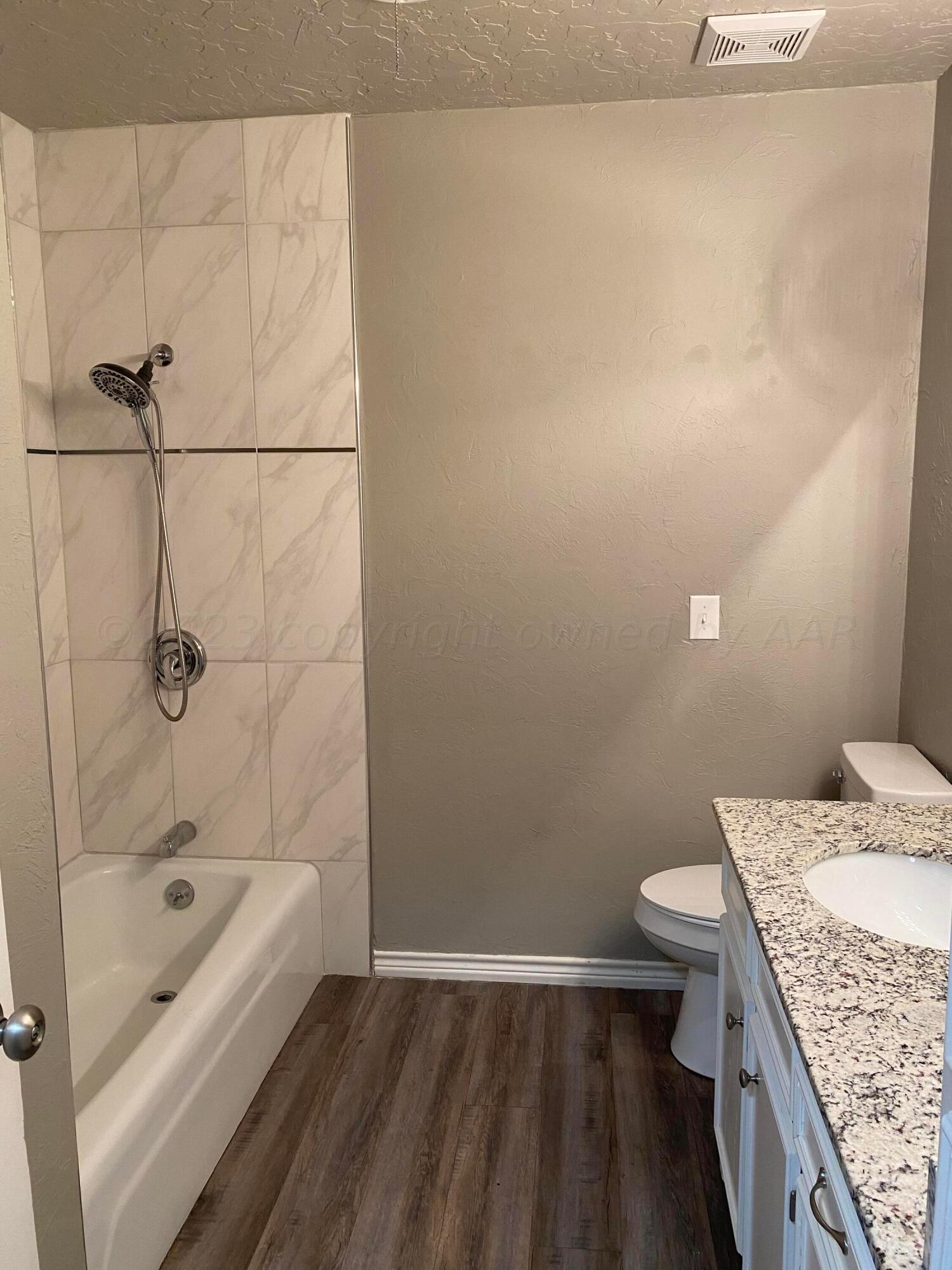7111 Imperial Trail Amarillo, TX 79106 - Photo 11 of 13 a bathroom with a granite countertop sink a toilet and shower