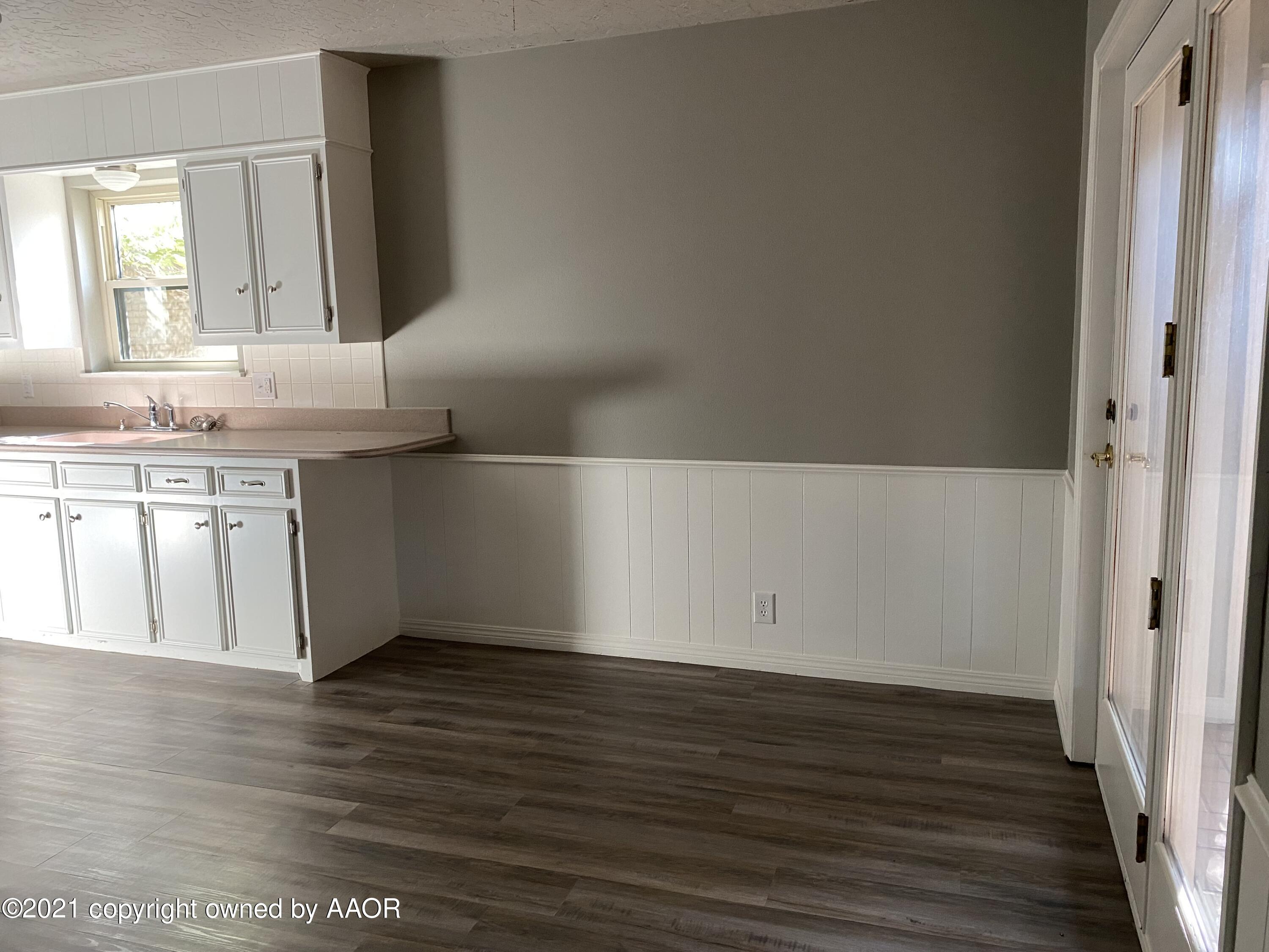 7111 Imperial Trail Amarillo, TX 79106 - Photo 4 of 13 a view of a kitchen with wooden floor and electronic appliances
