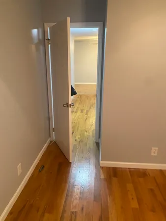 an empty room with wooden floor