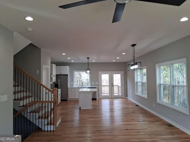 a view of an entryway with wooden floor and a large window