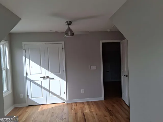 a view of an entryway with wooden floor