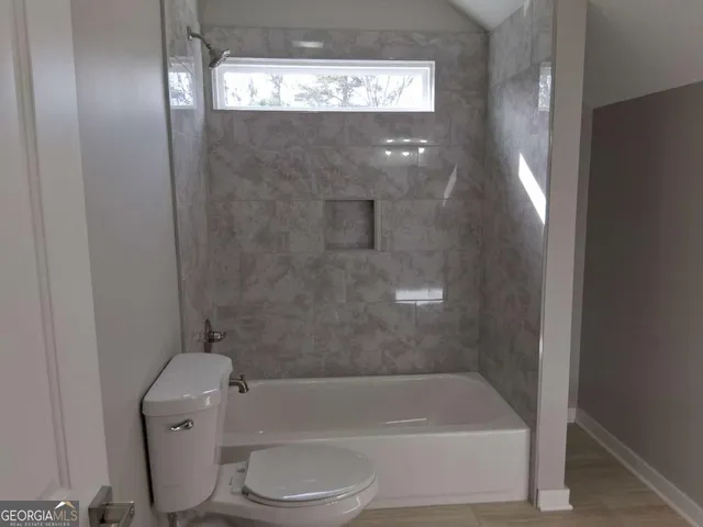 a bathroom with a bathtub and toilet
