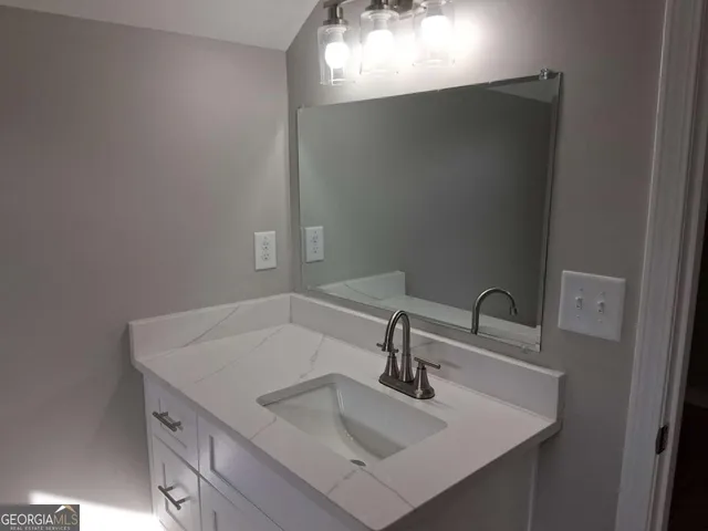 a bathroom with a sink and mirror
