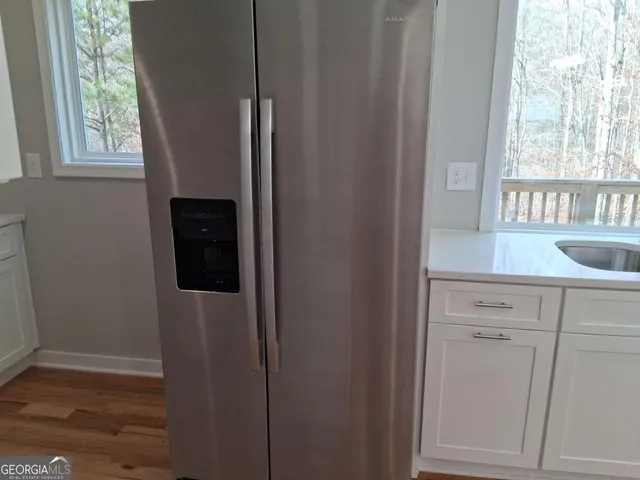 a view of kitchen with wooden floor washer and dryer