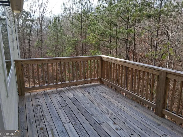 a balcony with wooden floor and fence