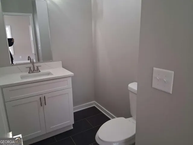 a bathroom with a sink a toilet and vanity