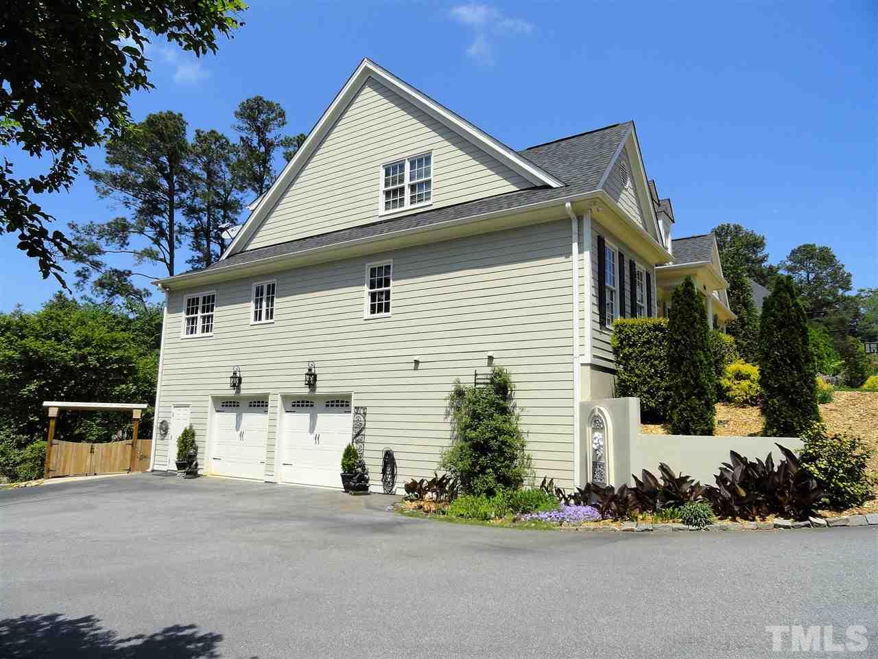 1004 Tyrrell Road Raleigh, NC 27609 - Photo 3 of 25 Double car garage, workshop, storage and finished family room with wet bar in basement!!!