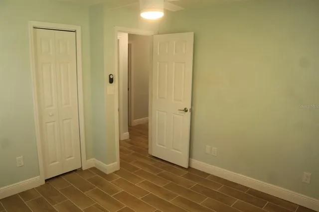 a view of a room with an empty space and a window