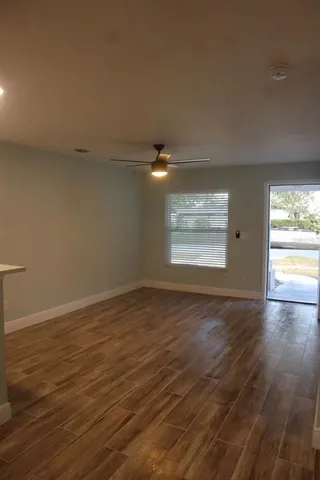 a kitchen with stainless steel appliances granite countertop a refrigerator a sink and wooden cabinets