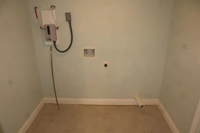 a view of empty room with wooden floor and window