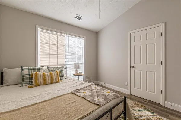 a bedroom with a bed and couch
