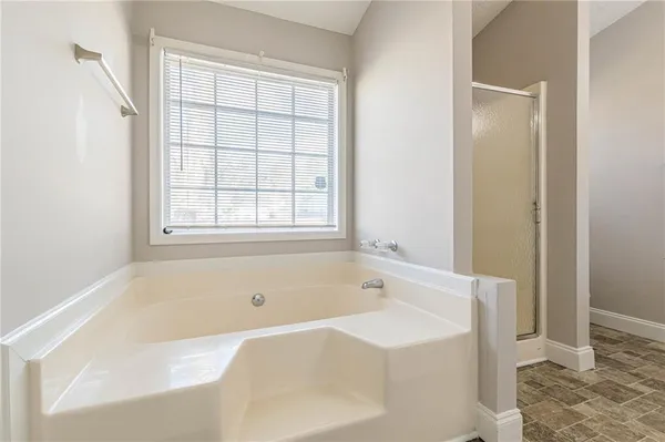 a white bath tub sitting next to a window
