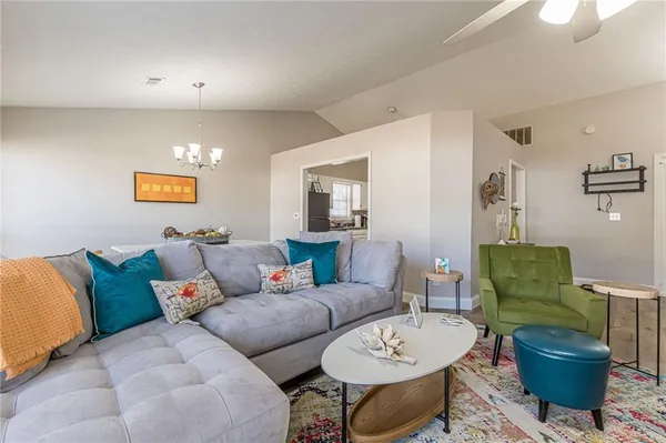 a living room with furniture a rug and a window