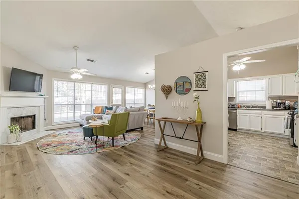 a living room with fireplace furniture and a wooden floor
