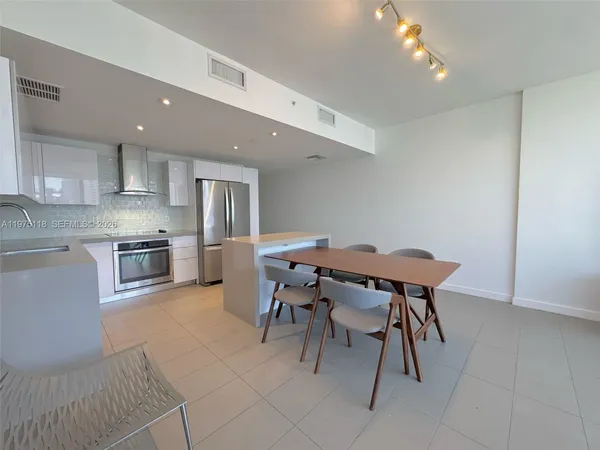 a open kitchen with a table and chairs in it