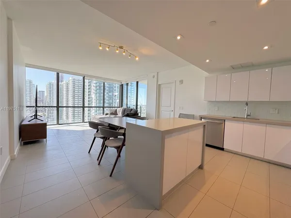 a large white kitchen with a large window