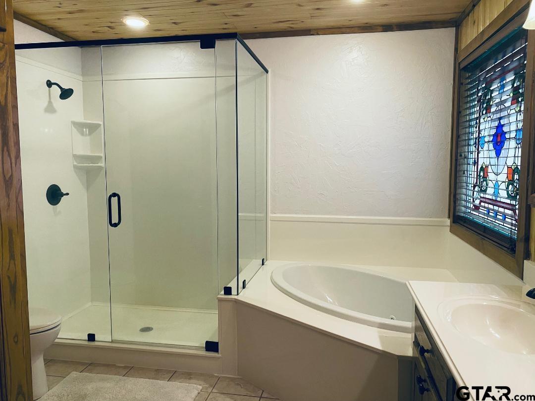1765 Crabapple Road Gilmer, TX 75645 - Photo 13 of 29 a bathroom with a tub and shower
