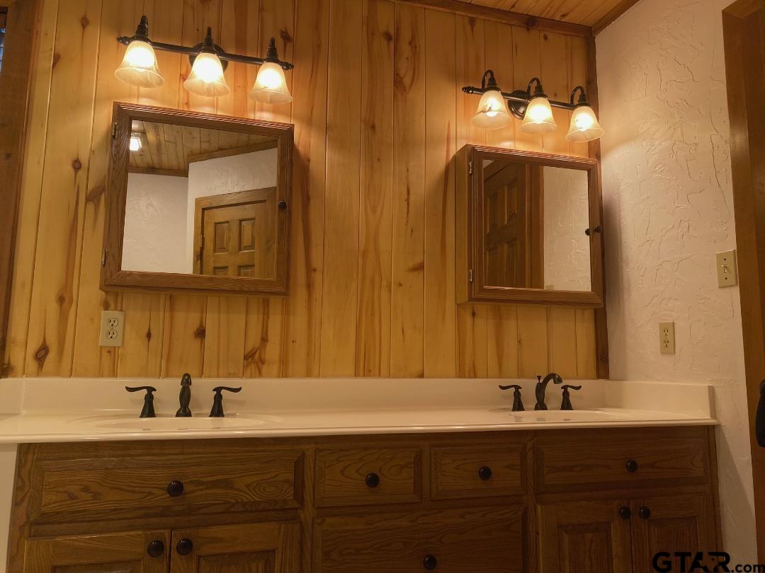 1765 Crabapple Road Gilmer, TX 75645 - Photo 14 of 29 a bathroom with a sink and a mirror