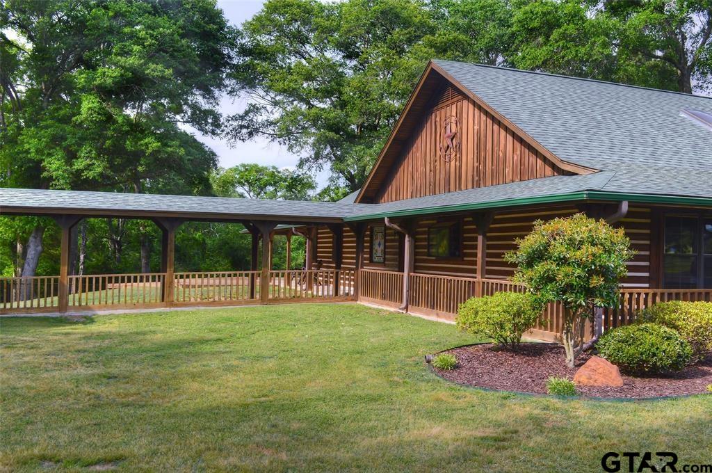 1765 Crabapple Road Gilmer, TX 75645 - Photo 2 of 29 a view of backyard with table and chairs and potted plants