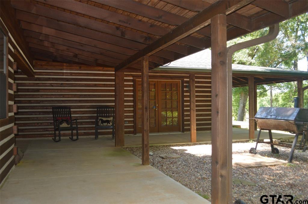 1765 Crabapple Road Gilmer, TX 75645 - Photo 3 of 29 a view of a porch with furniture and a yard