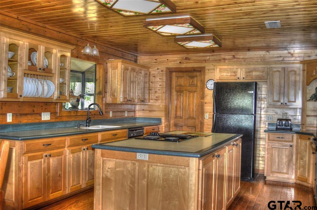 1765 Crabapple Road Gilmer, TX 75645 - Photo 6 of 29 a kitchen with stainless steel appliances granite countertop a sink a stove and cabinets