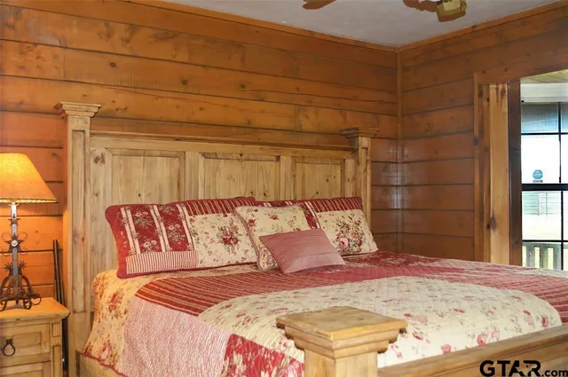 a bed sitting in a bedroom next to a window